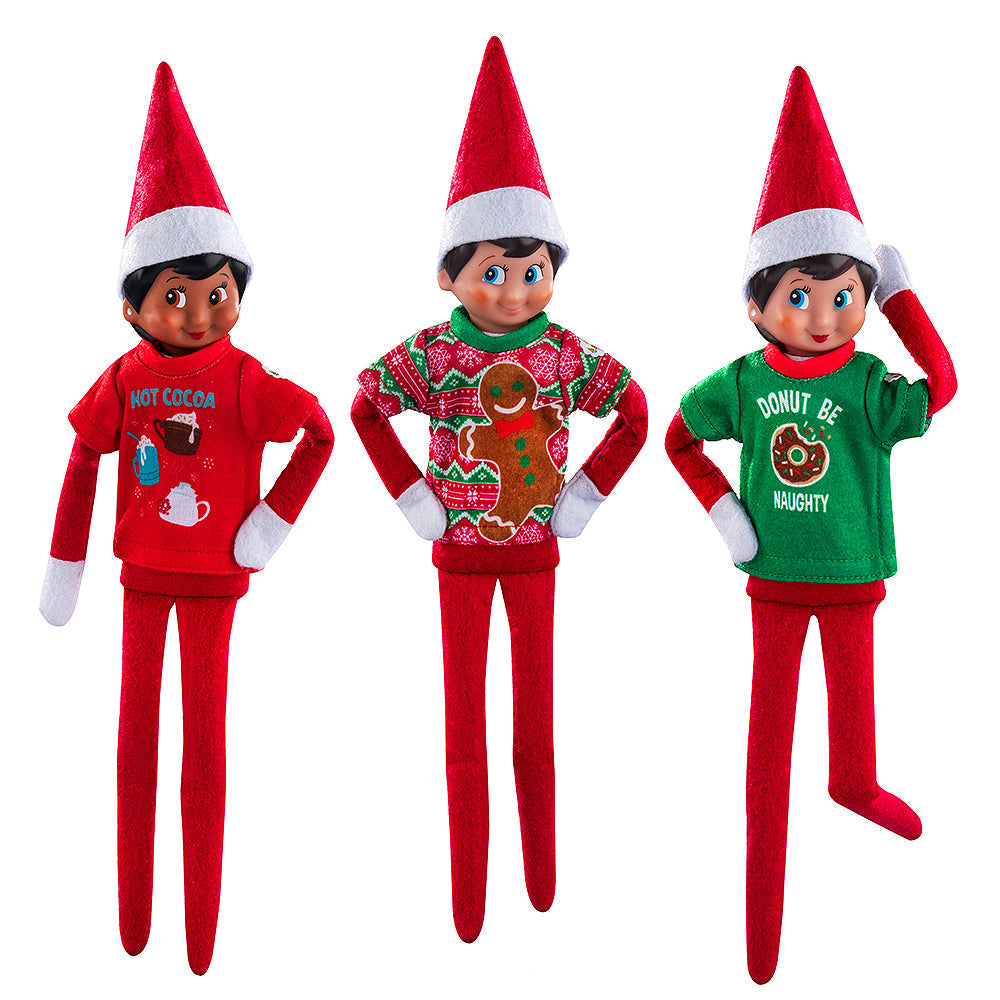 A trio of Scout Elves, each sporting a t-shirt from the Claus Couture Collection® Festive Fun T-Shirt Set.