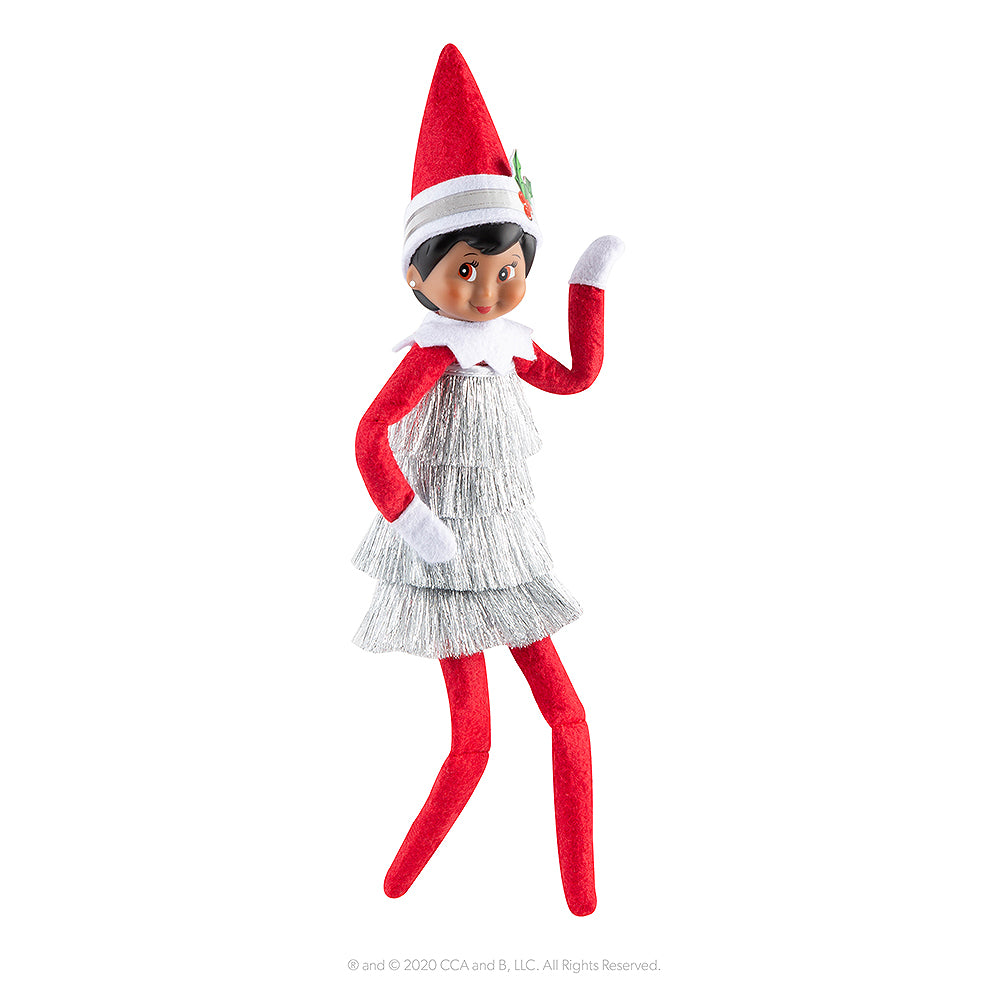 A girl Scout Elf® poses in the Claus Couture Collection® Tiny Tinsel Dress with included headband.