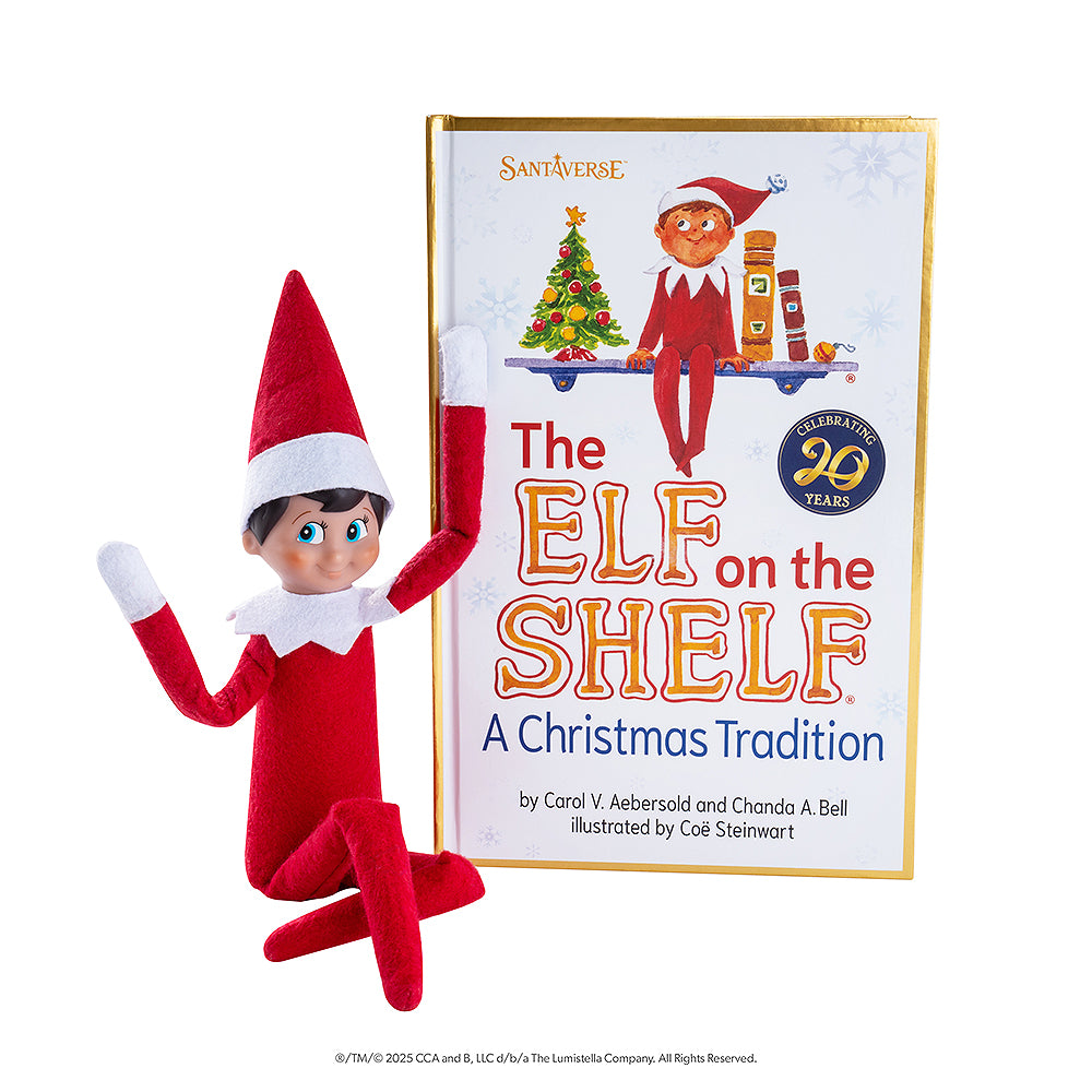 The adoptable boy limited-edition 20th anniversary Scout Elf® with blue eyes and flexible bending limbs for even easier elf scenes, pictured alongside the artfully illustrated 20th anniversary edition storybook.