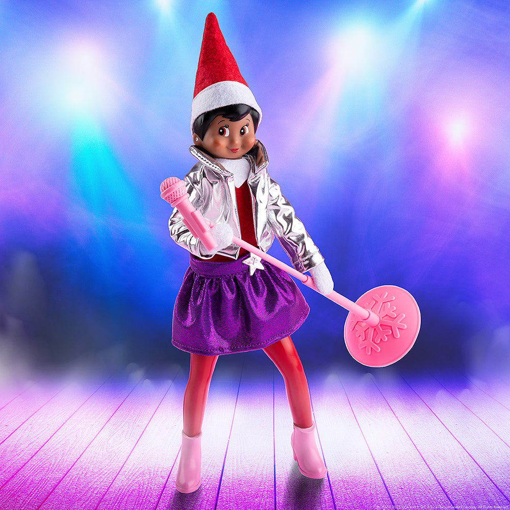 A lifestyle image of a girl Scout Elf staged with the MagiFreez® Pop Star set in front of stage lighting.