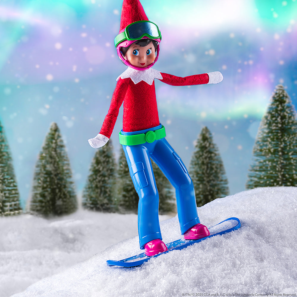 A wintery lifestyle image of a girl Scout Elf shredding the slopes while wearing the MagiFreez® Swish and Sleigh Snowboard Set.