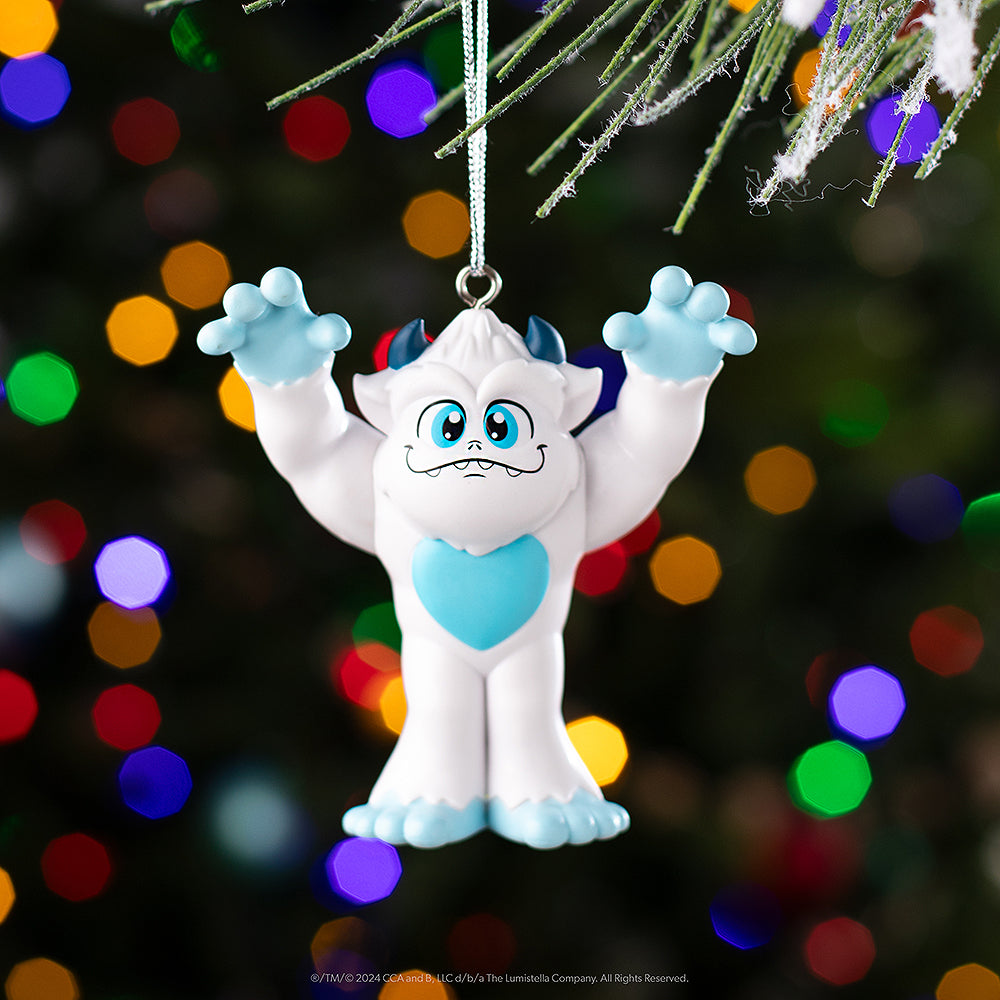 SnoBiggie™ Yeti ornament hanging from a Christmas tree
