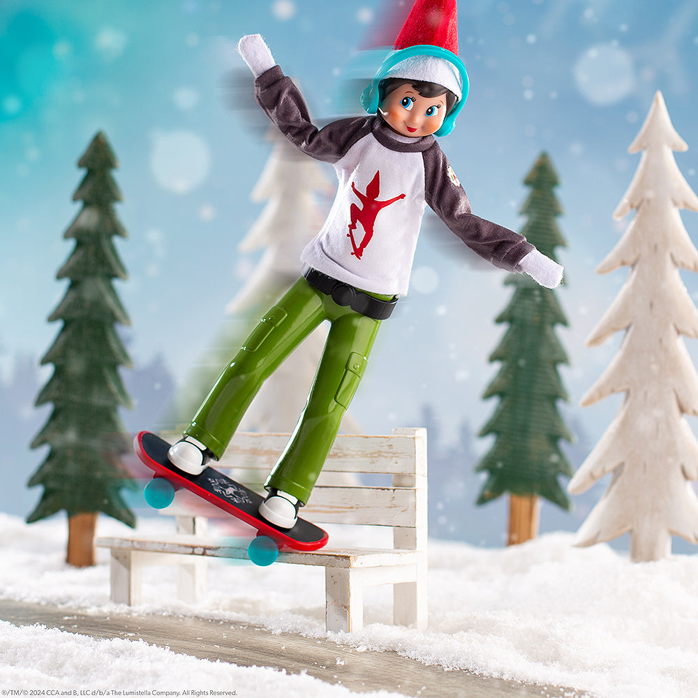 A Scout Elf donning the MagiFreez® Holly Jolly Ollie Skateboard Set, grinding on a bench in a snowy, winter wonderland