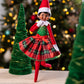 Scout Elf® sporting Claus Couture Collection® Gifts & Glamour Party Dress in a Christmas forest arrangement made of Christmas decor