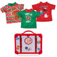 A flat lay view of the Claus Couture Collection® Festive Fun T-Shirt Set: a green tee with red collar with a donut graphic and the words, "Donut Be Naughty", a red tee with hot cocoa graphics and the words, "Hot Cocoa", and a green and red Fair Isle pattern with snowflakes and a large gingerbread man graphic. Also shown is the red and white plastic storage suitcase, adorned with passport stamps and stickers.