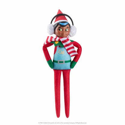 The Elf Mates® Chef with black hair, posed standing with his hands on his hips. He is wearing a set of earmuffs and a scarf.