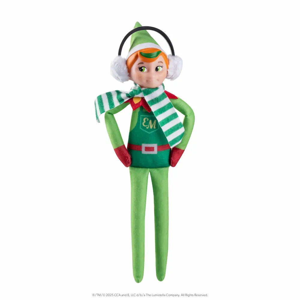 The Elf Mates® Cobbler with red hair, posed standing with his hands on his hips. He is wearing a set of earmuffs and a scarf.