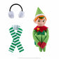 The Elf Mates® Cobbler with red hair, posed sitting holding his knees to his chest. To the left of the elf is a set of earmuffs and a scarf.