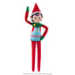 The Elf Mates® Chef girl doll poses standing while waving with her right hand and her left hand is resting on her hip. The Elf Mates Chef wears a red suit with green mittens and collar under a light blue apron with pink belt. The apron has a pocket with the EM insignia in yellow. Also in yellow is a heart on her green collar.