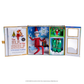 A open-faced view of the limited edition, collectable Swarovski® packaging of the 20th anniversary commemorative keepsake box with Swarovski® touches, featuring the posable Scout Elf® adorned in Swarovski® crystals, the artfully illustrated 20th anniversary edition storybook, limited-edition luxury satin long pajama set, limited-edition keepsake Scout Elf® ornament. 