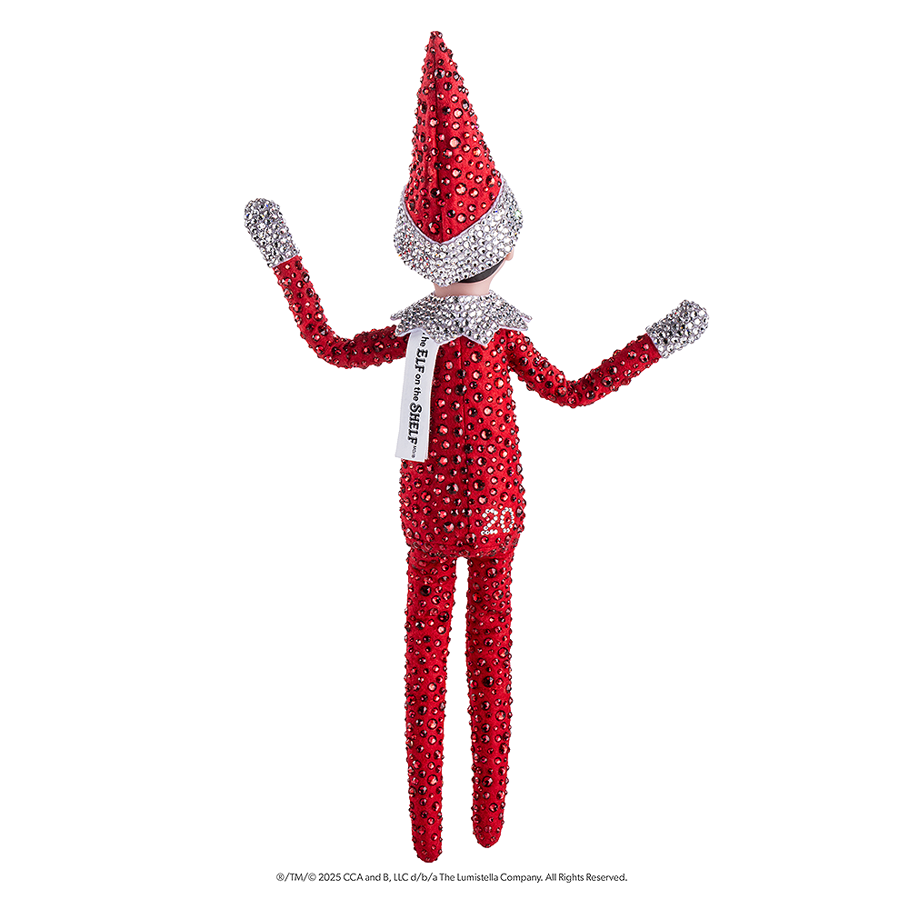 The included Scout Elf® boy with blue eyes poses to show off his flexible bending limbs for even easier elf scenes. The view is that of his back. Most notably, he is adorned from head to toe in Swarovski® crystals that coordinate with his signature style.