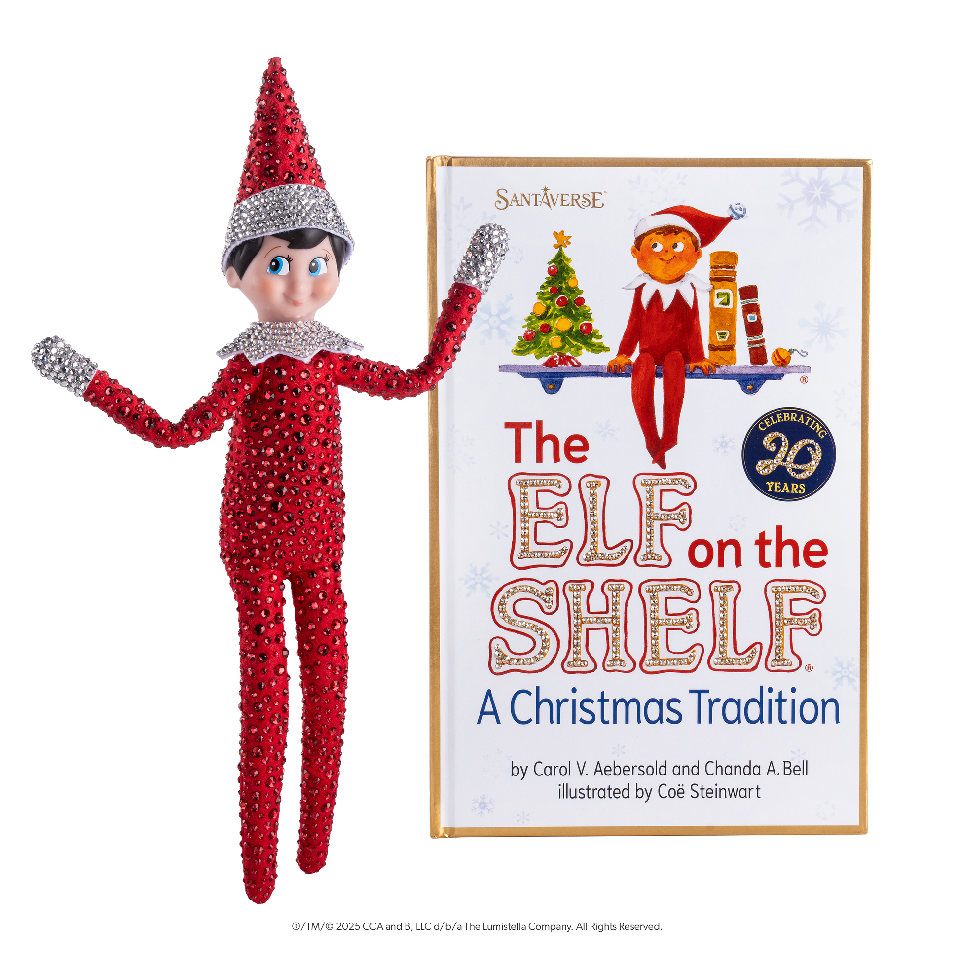 An image of the Scout Elf® posing with his arms outstretched, showcasing his Swarovski® lined suit and hat on the left, as well as the artfully illustrated 20th anniversary edition storybook, of which the cover is also adorned in Swarovski® crystals on the words "Elf" and "Shelf" on the right.