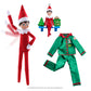 An image featuring the included contents of the The Elf on the Shelf®: A Christmas Tradition, Limited 20th Anniversary Edition. This includes a limited-edition 20th anniversary boy Scout Elf® with blue eyes and flexible bending limbs for even easier elf scenes, limited-edition luxury satin long pajama set and limited-edition keepsake Scout Elf® ornament.