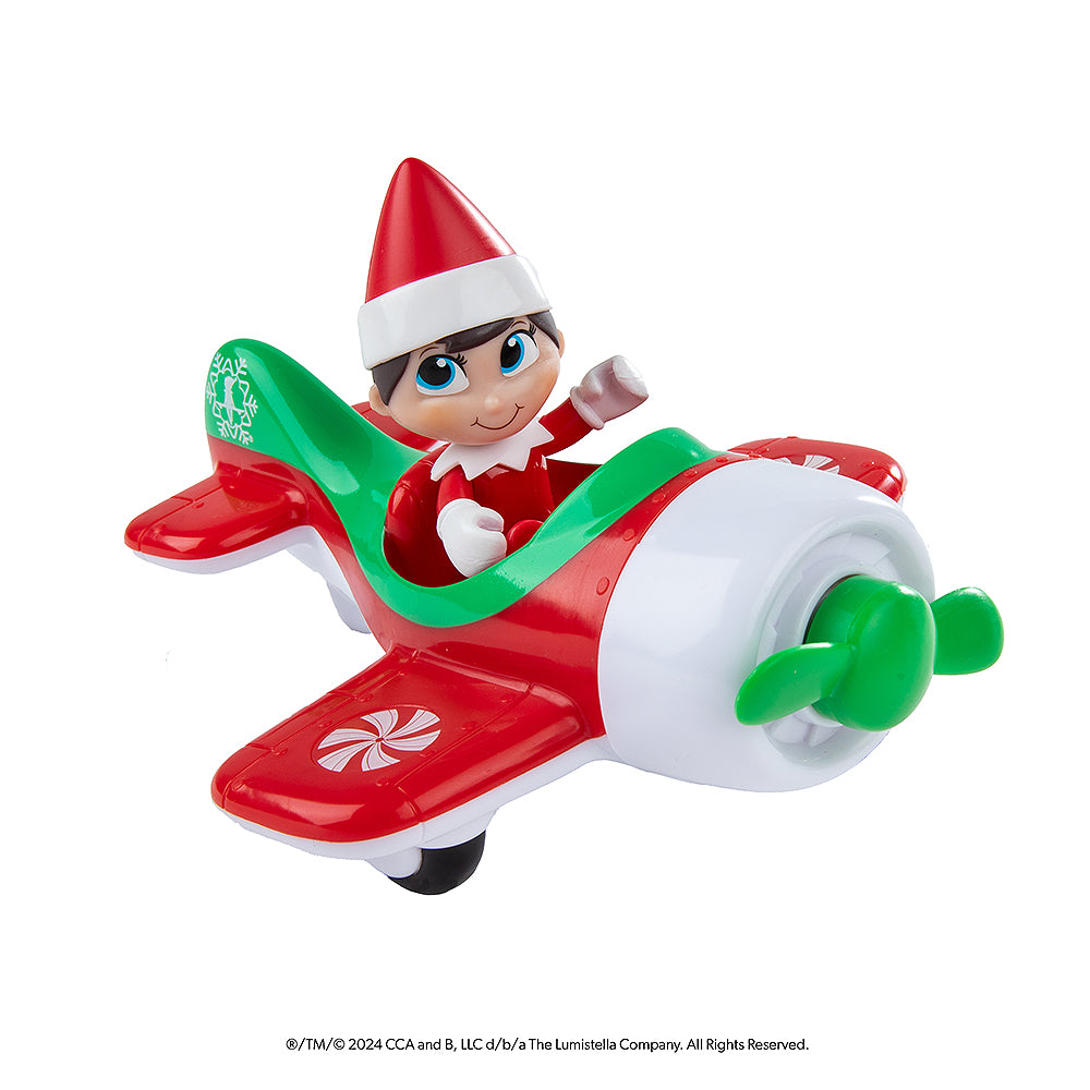 The Elf on the Shelf® Action Figure Play Pack: Flight Edition plane with the Scout Elf® figurine sitting in the pilot's seat