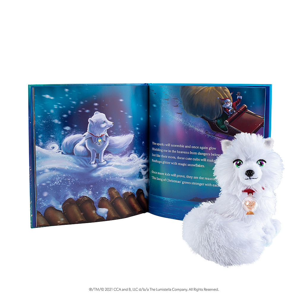 Elf Pets: An Arctic Fox Tradition book opened to showcase the beautiful illustration alongside the Arctic Fox plush