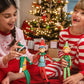 Siblings playing with the Elf MatesElf Mates® Chef, Cobbler and Toy Maker dolls with a Christmas Tree in the background