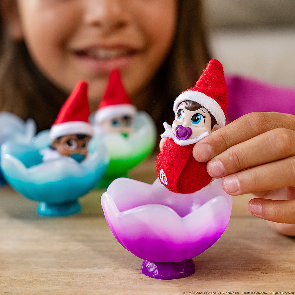 A little girl playing with the Frost Pips™ Mini Blooms