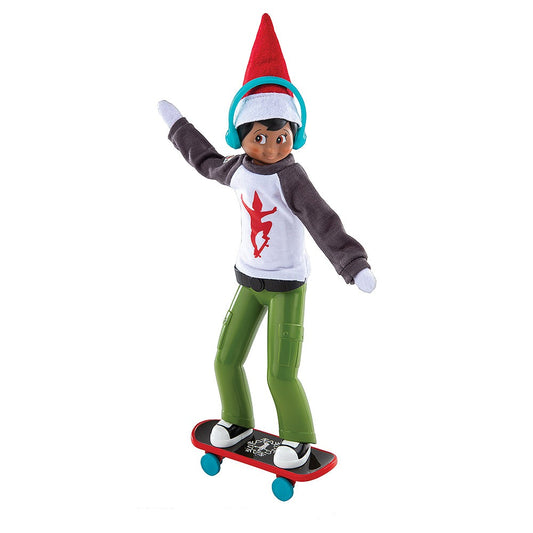 A Scout Elf® posed in the MagiFreez® Holly Jolly Ollie Skateboard Set