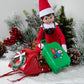 Scout Elf® with Polar Props™  Travel Set suitcase loaded up on a Christmasy snowmobile