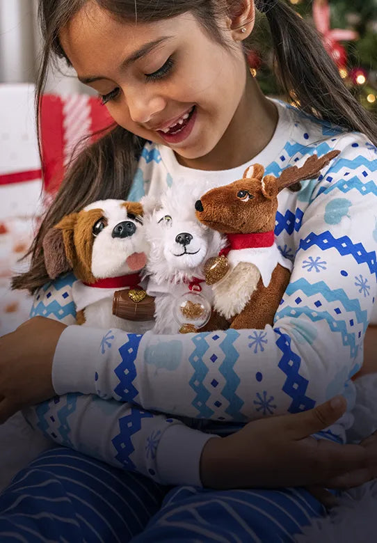 A girl in her pajamas hugging an Elf Pets Saint Bernard, Arctic Fox, and Reindeer