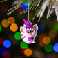 Bogie™ pal ornament hanging from a Christmas tree