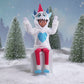 A Scout Elf® sitting in a snowy forest donning the Claus Couture Collection® Yeti Hoodie Set, spinning around in this product video to give customers a 360 degree view of the product