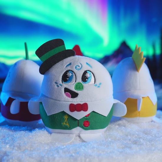 Product video showing all four playable plush celebration snowmen on a turntable in a snowy environment with the Northern Lights overhead. These pint-sized North Pole pals are stirring up a celebration for the 20th year of The Elf on the Shelf®! Collect all four and celebrate the season!