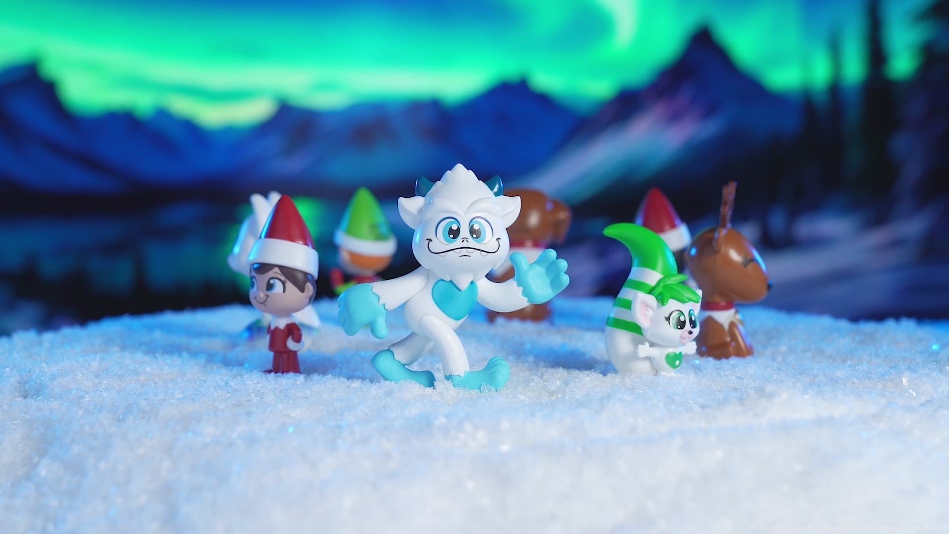 A product video of the Santaverse™ Minis (Series 5) rotating over snowy ground with a mountainous, wintery, out-of-focus background.