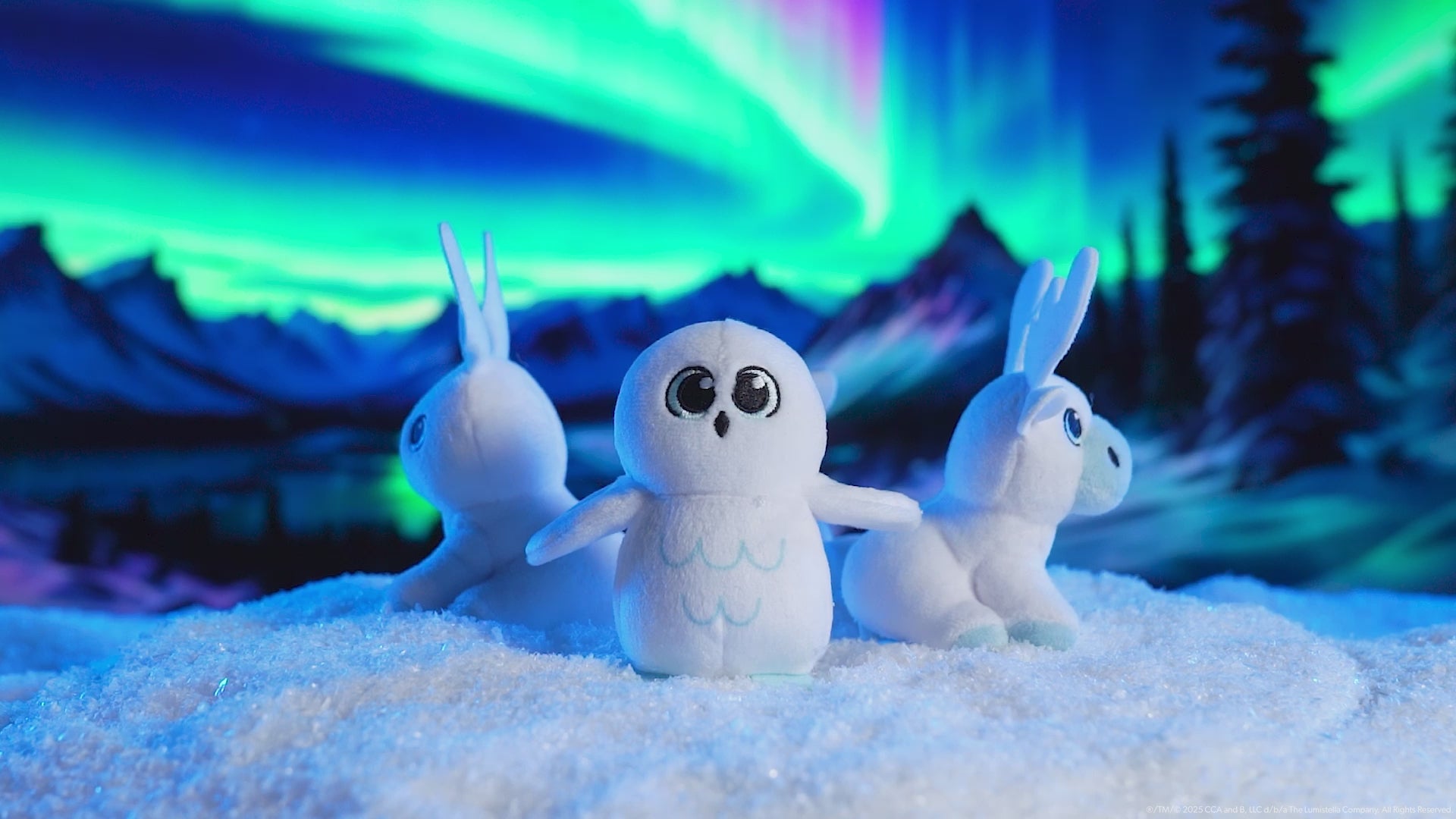This product video features the 4 mini plush snow sculpture designs spinning on a turntable. You could find any one of these plushes in your Noorah™ Snow Sculpture Surprise. They are posing in an arctic environment with snowy conifer trees and the Northern Lights overhead.