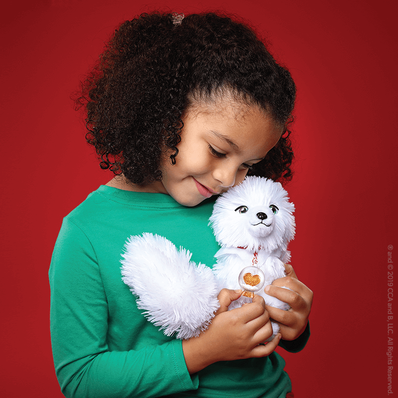 Kid holding an Elf Pets®: An Arctic Fox Tradition